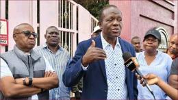 Former Foreign Affairs Minister Raphael Tuju address the press outside his property.